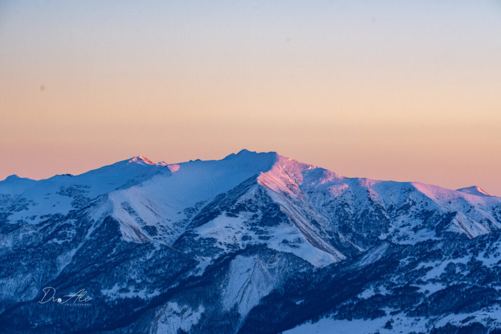 Alpenglow pink snow ridges