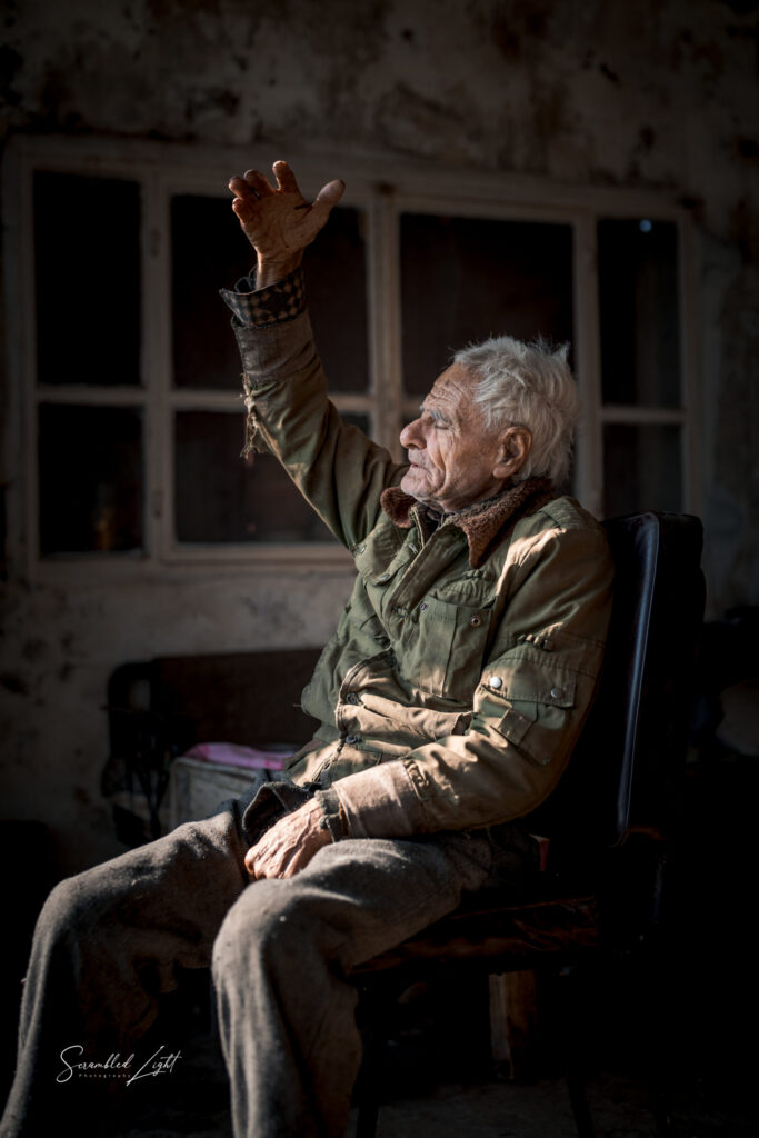 Elder hand raised window light